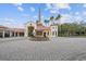 Elegant community entrance featuring a stone monument and well-manicured landscaping at 777 Glendora Road, Poinciana, FL 34759