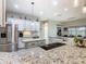Modern kitchen featuring stainless steel appliances, granite countertops, and ample cabinet space at 777 Glendora Road, Poinciana, FL 34759