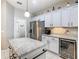 Modern kitchen with granite counters, wine fridge, and stainless-steel refrigerator at 777 Glendora Road, Poinciana, FL 34759