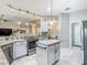 Well-equipped kitchen featuring granite countertops, stainless steel appliances, and pendant lights at 777 Glendora Road, Poinciana, FL 34759