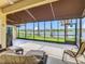 Spacious screened lanai offering picturesque views of the lake with comfortable seating at 777 Glendora Road, Poinciana, FL 34759