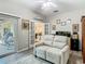 Living room view with sliding glass doors, french doors, and desk area near the kitchen at 777 Glendora Road, Poinciana, FL 34759