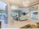 Open-concept living room boasts tile flooring, neutral paint, modern light fixture, and access to the lanai at 777 Glendora Road, Poinciana, FL 34759