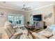 Cozy living room with comfortable seating, a large TV, and sliding glass doors leading to the outdoor patio at 777 Glendora Road, Poinciana, FL 34759