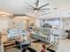 Open-concept living room and kitchen featuring modern lighting, stylish furniture, and stainless steel appliances at 777 Glendora Road, Poinciana, FL 34759