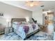 Cozy main bedroom featuring a ceiling fan, ensuite bathroom, and stylish modern decor at 777 Glendora Road, Poinciana, FL 34759