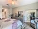 Main bedroom with sliding glass doors to patio and comfortable seating area at 777 Glendora Road, Poinciana, FL 34759