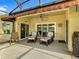 Inviting screened-in patio with comfortable seating, a ceiling fan, and serene views of the surrounding landscape at 777 Glendora Road, Poinciana, FL 34759