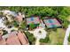 Aerial view of the community's well-maintained pickleball courts, pool and surrounding tropical landscaping at 777 Glendora Road, Poinciana, FL 34759