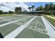 Well-maintained shuffleboard courts with shaded seating offer recreational opportunities for residents at 777 Glendora Road, Poinciana, FL 34759