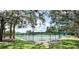 A tranquil tennis court surrounded by lush greenery, offering a private and serene recreational experience at 777 Glendora Road, Poinciana, FL 34759