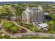 An aerial view of a large resort building, golf course, and putting green, with well-maintained landscaping at 7802 Palmilla Ct, Reunion, FL 34747