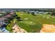 Stunning aerial view of a golf course community with pristine greens, sand traps, and luxurious homes at 7802 Palmilla Ct, Reunion, FL 34747