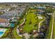 Lush landscaping with ample green space featuring putting green, playground and white sand volleyball court at 7802 Palmilla Ct, Reunion, FL 34747