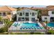 Expansive backyard with a sparkling pool, inviting lounge chairs, and outdoor dining for luxurious living at 7802 Palmilla Ct, Reunion, FL 34747