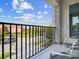 A cozy balcony with a beautiful view, featuring comfortable seating and elegant stone detailing on the columns at 7802 Palmilla Ct, Reunion, FL 34747