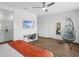 Modern bedroom featuring wood-look floors, a unique hanging chair, and sleek workstation at 7802 Palmilla Ct, Reunion, FL 34747