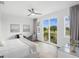 Bright bedroom with large windows offering golf course views, a chaise lounge, and modern decor at 7802 Palmilla Ct, Reunion, FL 34747