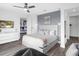 Features a modern white bedroom with sports-themed decor, sleek furniture, and hardwood flooring, creating a fun atmosphere at 7802 Palmilla Ct, Reunion, FL 34747
