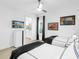 The bedroom features twin beds with sleek black accents, vibrant artwork, and an ensuite bathroom for added convenience at 7802 Palmilla Ct, Reunion, FL 34747