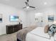 This bedroom offers a serene retreat with a calming palette, a modern dresser, and a glimpse into a well-lit bathroom at 7802 Palmilla Ct, Reunion, FL 34747