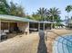 Relaxing pool area with private cabanas, lounge seating, and tropical landscaping at 7802 Palmilla Ct, Reunion, FL 34747