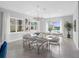 Bright dining area with modern chandeliers and glass-top dining table, perfect for gatherings and entertaining at 7802 Palmilla Ct, Reunion, FL 34747
