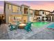 Backyard with a pool, fire pit, and outdoor kitchen area at 7802 Palmilla Ct, Reunion, FL 34747