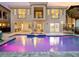 Stunning exterior of the home overlooking the backyard pool and patio with outdoor grill at 7802 Palmilla Ct, Reunion, FL 34747