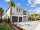 Contemporary two-story home featuring a two-car garage, neutral stone accents, and well-maintained landscaping at 7802 Palmilla Ct, Reunion, FL 34747