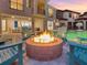 Outdoor oasis featuring a cozy brick fire pit surrounded by Adirondack chairs near a beautiful pool at 7802 Palmilla Ct, Reunion, FL 34747