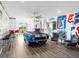 Unique game room with a car-themed pool table, bar area, and wall decor for endless entertainment at 7802 Palmilla Ct, Reunion, FL 34747
