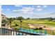 Scenic view of a lush golf course from a balcony with lounge chairs, perfect for relaxing at 7802 Palmilla Ct, Reunion, FL 34747