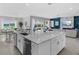 Open-concept kitchen with island and stainless appliances flows into the living and dining areas, offering seamless living at 7802 Palmilla Ct, Reunion, FL 34747
