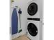 Laundry room featuring stacked washer and dryer along with cleaning supplies at 7802 Palmilla Ct, Reunion, FL 34747