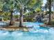 Tranquil lazy river with inner tubes, waterfalls, and verdant tropical landscaping at 7802 Palmilla Ct, Reunion, FL 34747