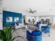 Open concept living room with stylish decor and adjacent kitchen and staircase at 7802 Palmilla Ct, Reunion, FL 34747