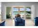 Bright living room features sliding glass doors to a patio with a pool view and ample natural light at 7802 Palmilla Ct, Reunion, FL 34747