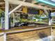 Charming outdoor bar offering refreshing beverages and a relaxing atmosphere with an outdoor grill and shaded seating areas at 7802 Palmilla Ct, Reunion, FL 34747