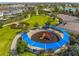 Aerial view of a community playground and green space with ample room to play and featuring a picnic area at 7802 Palmilla Ct, Reunion, FL 34747