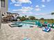 Beautiful pool and patio area featuring lots of seating, a grill, and a basketball hoop at 7802 Palmilla Ct, Reunion, FL 34747