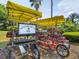 Unique bike with multiple seats and sun covers next to Reunion Resort signage, ideal for leisurely exploration at 7802 Palmilla Ct, Reunion, FL 34747