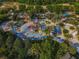 Aerial view of a community water park with a splash pad, pools, and many chairs at 7802 Palmilla Ct, Reunion, FL 34747