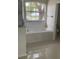 Bathroom with tub and window at 808 Massy Ct, Kissimmee, FL 34759