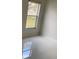 Small but cozy bedroom featuring tile floors, neutral walls, and a large window that gets great natural light at 808 Massy Ct, Kissimmee, FL 34759