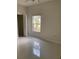 Bright bedroom with tile floors and natural light from a large window at 808 Massy Ct, Kissimmee, FL 34759