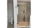 Bathroom features a glass shower enclosure, tiled walls and floors at 8919 Lakeshore Pointe Dr, Winter Garden, FL 34787