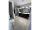 Bathroom features a double vanity, tiled floors, and frameless glass shower at 8919 Lakeshore Pointe Dr, Winter Garden, FL 34787
