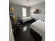Secondary bedroom with two twin beds, dark floors, and window with plantation shutters at 8919 Lakeshore Pointe Dr, Winter Garden, FL 34787