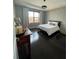Bedroom features a tray ceiling, accent wall, dark floors, and modern lighting at 8919 Lakeshore Pointe Dr, Winter Garden, FL 34787